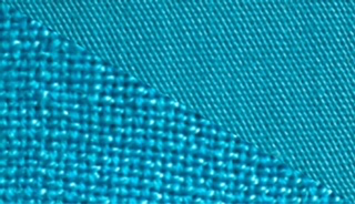 Fabric dyed in turquoise, demonstrating the vibrant color achieved with our fabric dye on different textures.